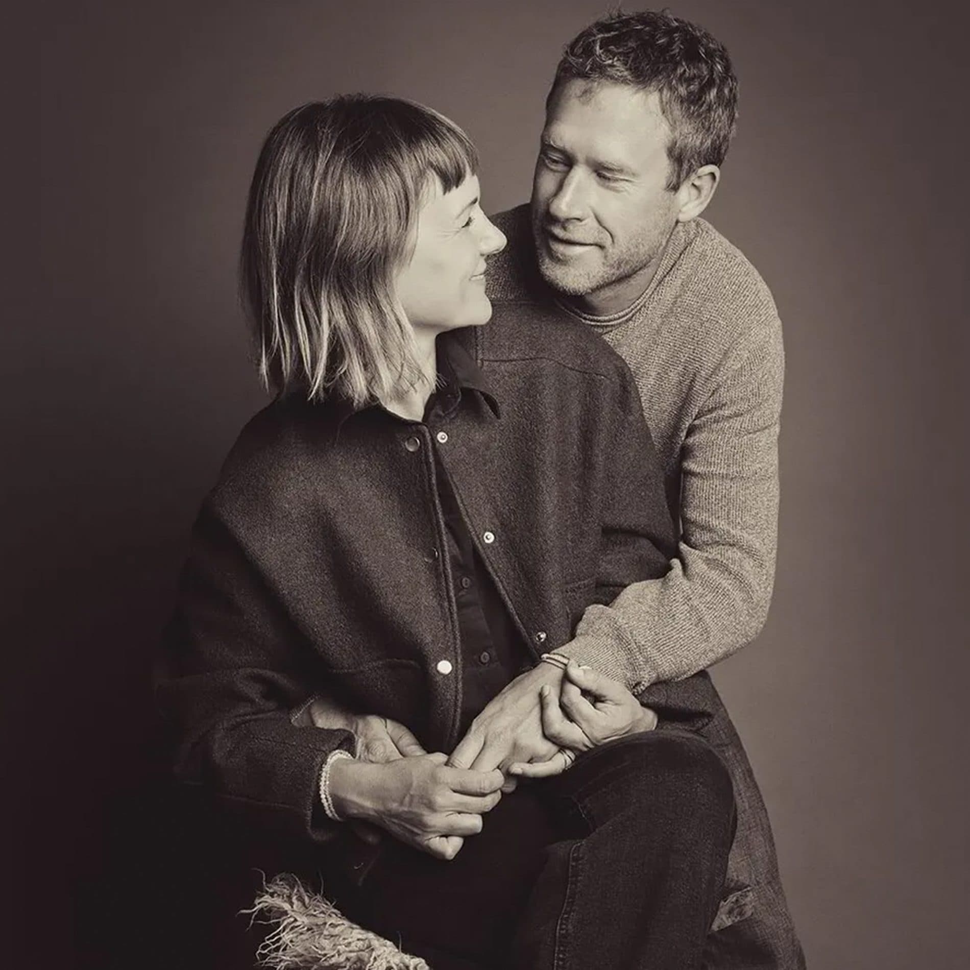 Un couple enlacé sur fond sombre, en tons sépia